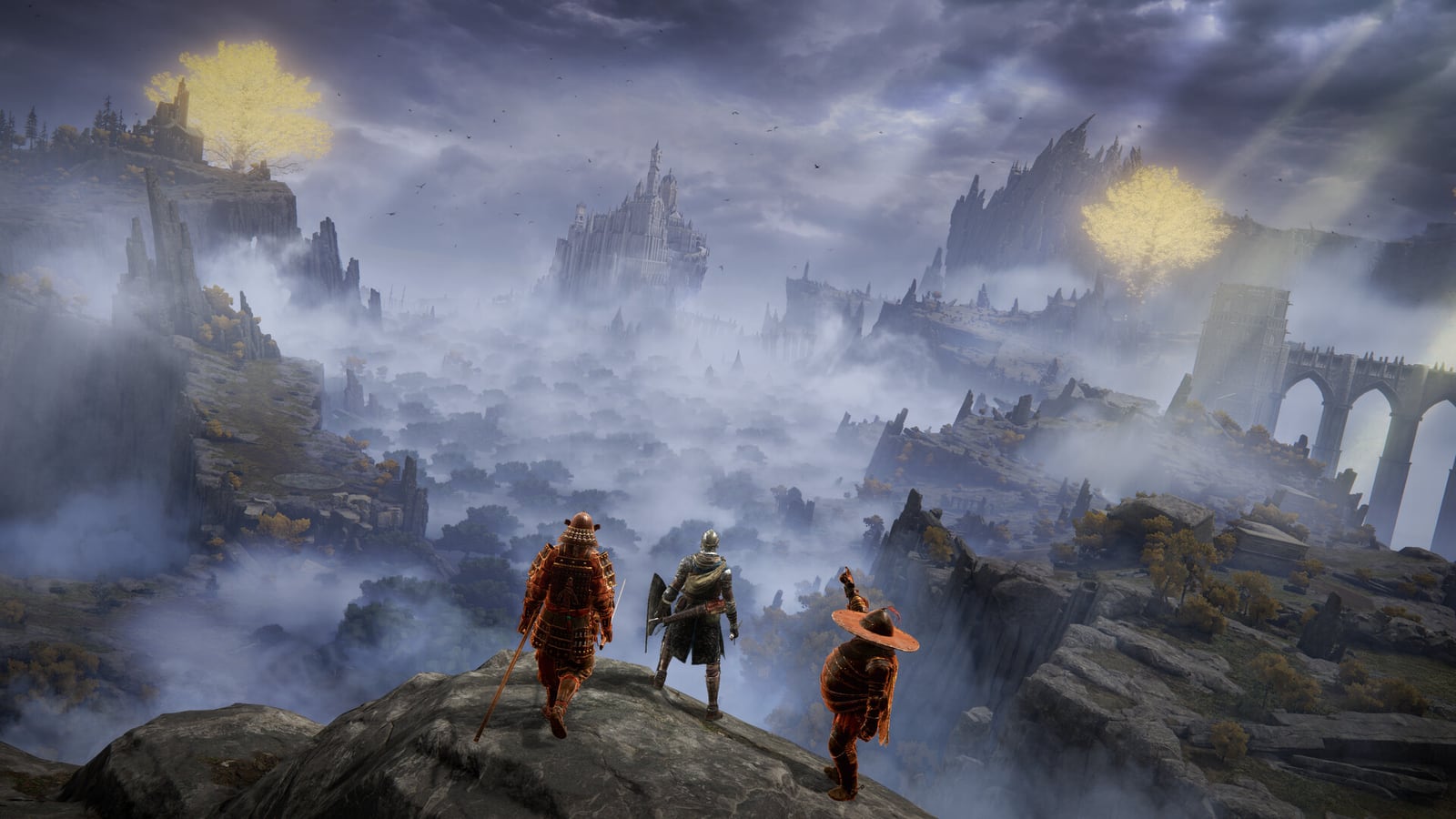 Three Tarnished standing on a cliff over misty ruins in Elden Ring
